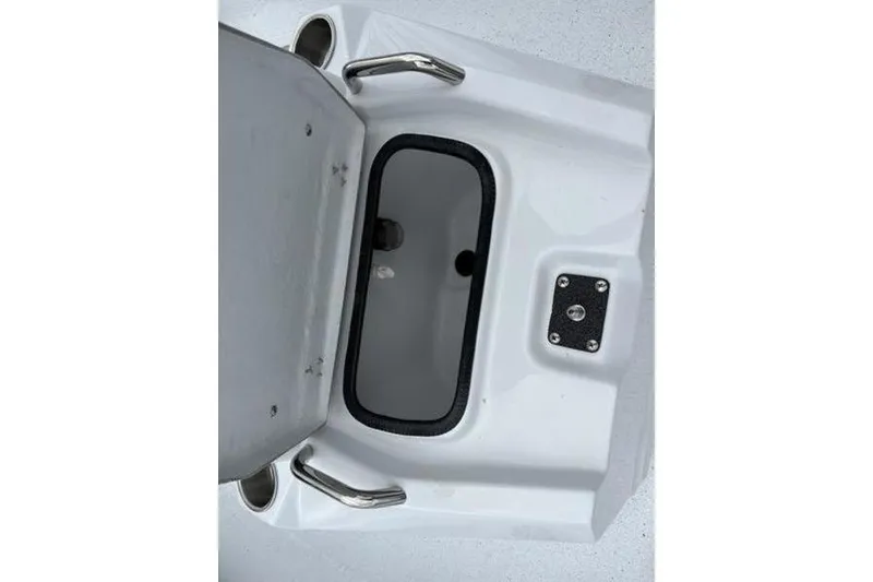 Slide: The Image of Open storage compartment on 2026 Xpress H20B Bay boat, featuring stainless steel handles. - 11