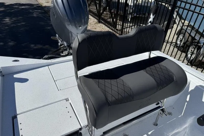 Slide: The Image of 2026 Xpress H20B Bay boat with cushioned seating and outboard motor. - 16