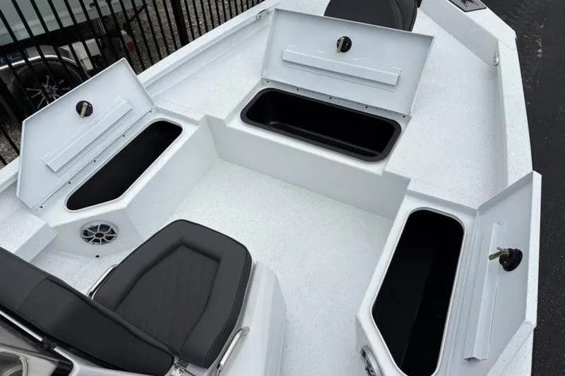 Slide: The Image of 2026 Xpress H20B Bay boat interior with open storage compartments and seating. - 7
