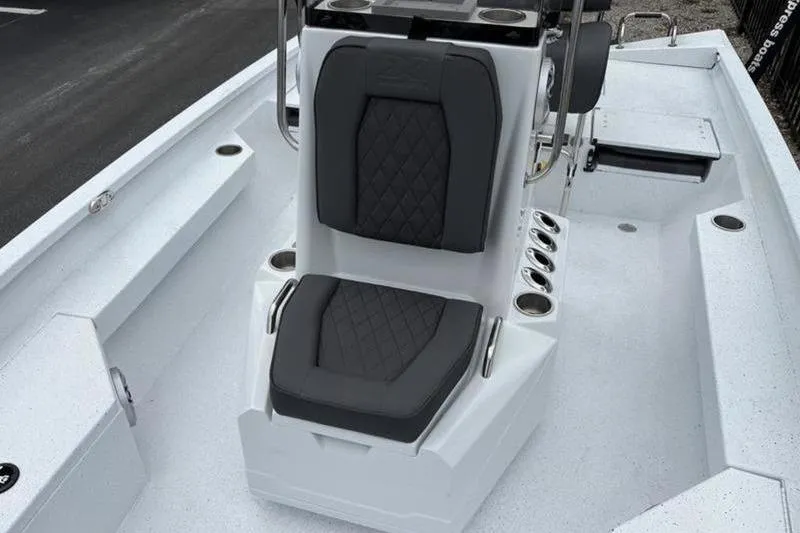 Slide: The Image of 2026 Xpress H20B Bay boat interior with cushioned seating and rod holders. - 9