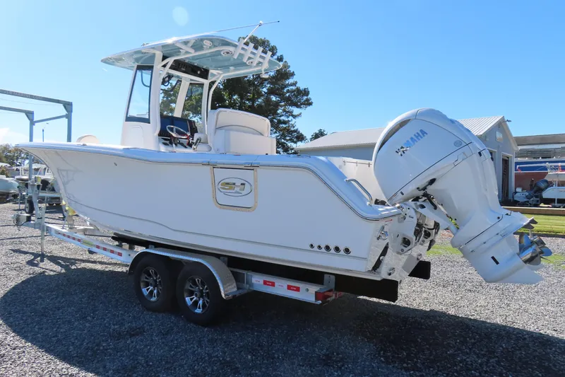 Slide: The Image of 2025 Sea Hunt Gamefish 27 boat on trailer with Yamaha engine, side view. - 2