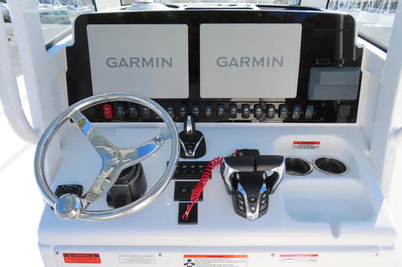 Slide: The Image of 2025 Sea Hunt Gamefish 27 helm with dual Garmin displays and modern controls. - 28