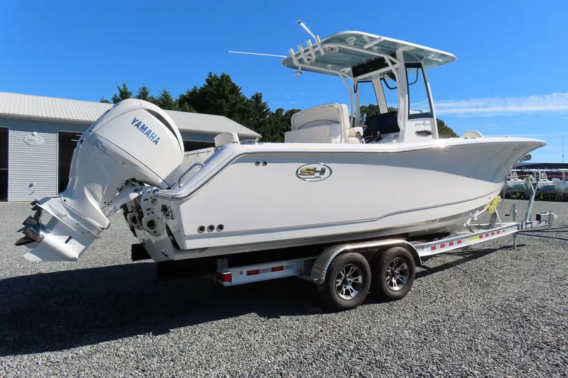 Slide: The Image of 2025 Sea Hunt Gamefish 27 Forward Seating boat on trailer, featuring Yamaha engine. - 3