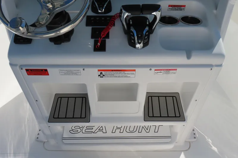 Slide: The Image of 2025 Sea Hunt Gamefish 27 console with steering wheel and controls, featuring forward seating. - 31