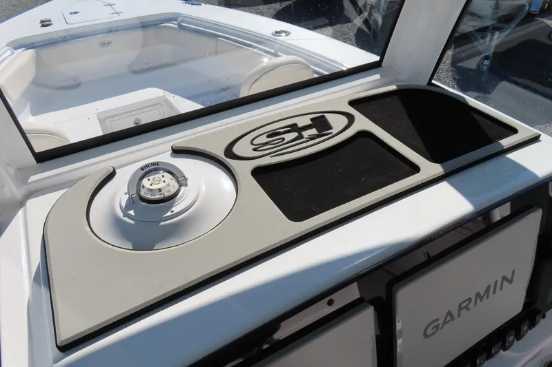 Slide: The Image of 2025 Sea Hunt Gamefish 27 dashboard with Ritchie compass and Garmin electronics. - 32