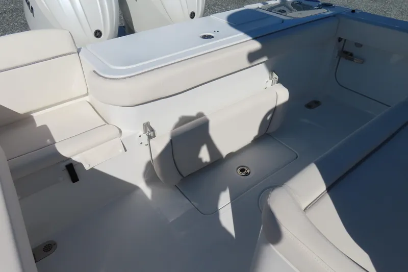 Slide: The Image of 2025 Sea Hunt Gamefish 27 Forward Seating interior with white cushioned seats and storage. - 38