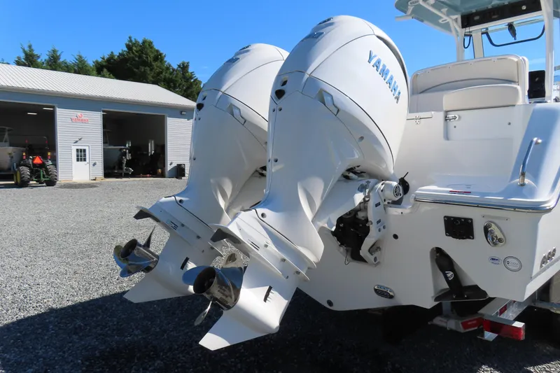 Slide: The Image of 2025 Sea Hunt Gamefish 27 with dual Yamaha outboard engines, parked near a garage. - 4