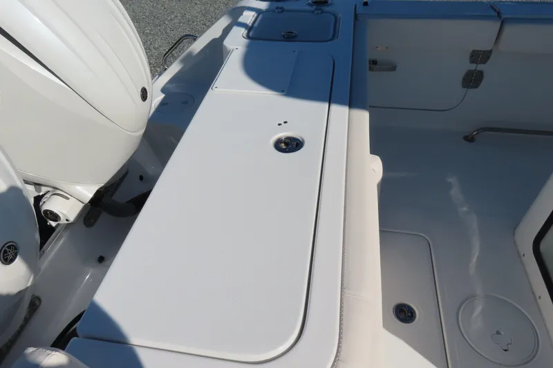 Slide: The Image of 2025 Sea Hunt Gamefish 27 Forward Seating boat interior with engine and storage compartments. - 46