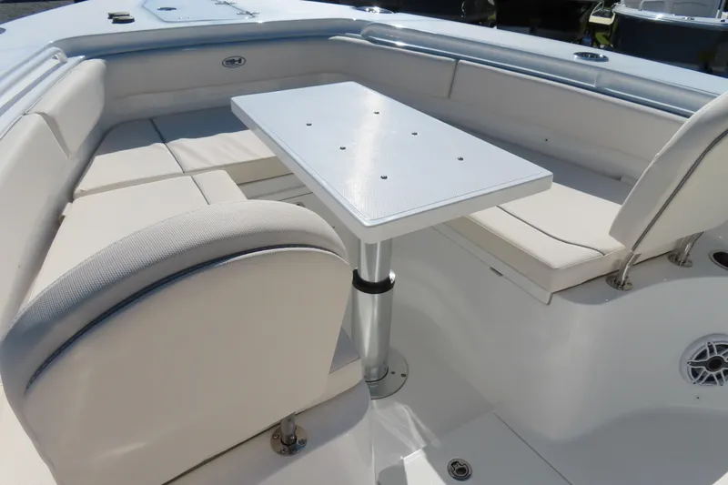 Slide: The Image of 2025 Sea Hunt Gamefish 27 Forward Seating with white cushioned seats and table. - 9