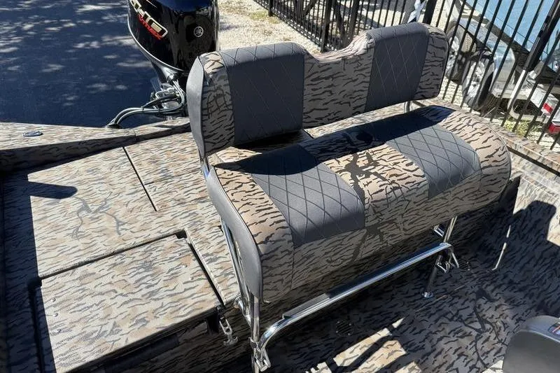 Slide: The Image of 2026 Xpress H20B Bay boat with patterned seating and Yamaha outboard motor. - 12