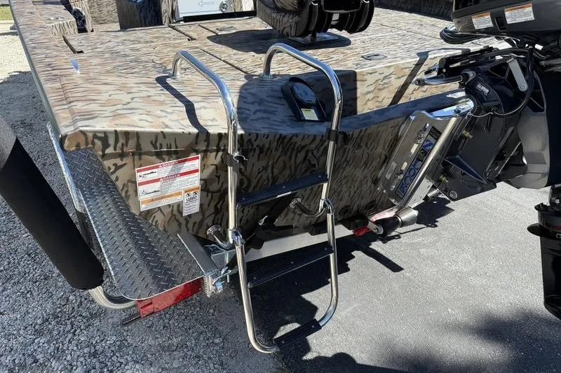 Slide: The Image of 2026 Xpress H20B Bay boat with camouflage design and rear ladder. - 16