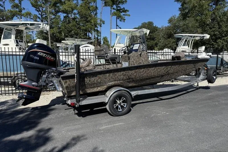 Slide: The Image of 2026 Xpress H20B Bay boat on trailer with Yamaha engine, parked outdoors. - 3