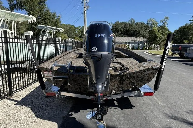Slide: The Image of 2026 Xpress H20B Bay boat with powerful outboard motor on trailer. - 4