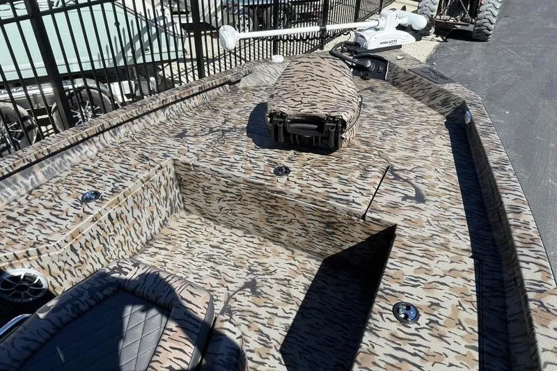 Slide: The Image of 2026 Xpress H20B Bay boat with camouflage pattern and deck storage. - 5