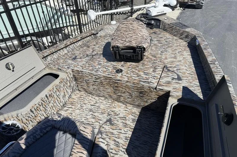 Slide: The Image of 2026 Xpress H20B Bay boat with camouflage design and storage compartments. - 6