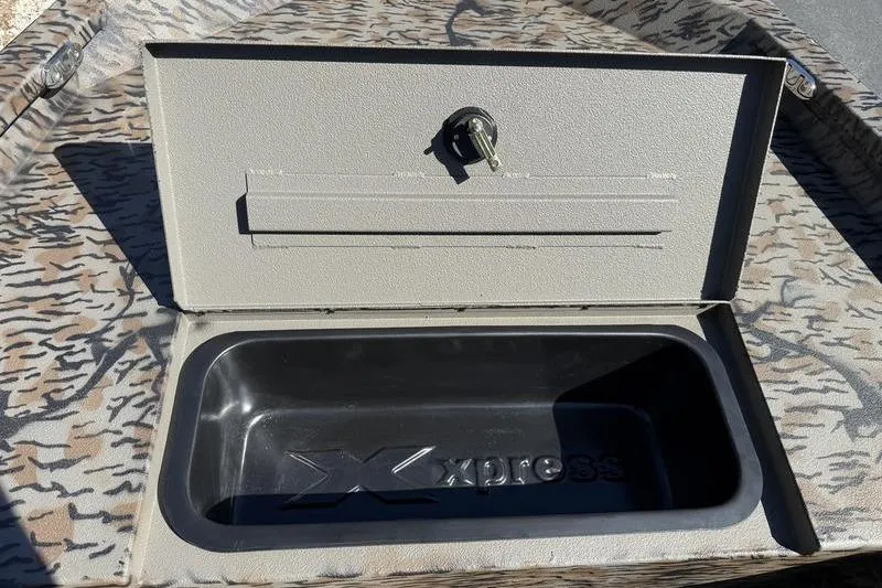 Slide: The Image of Open storage compartment on 2026 Xpress H20B Bay boat with camouflage pattern. - 7
