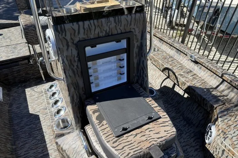 Slide: The Image of 2026 Xpress H20B Bay boat interior with camouflage design and storage compartments. - 9