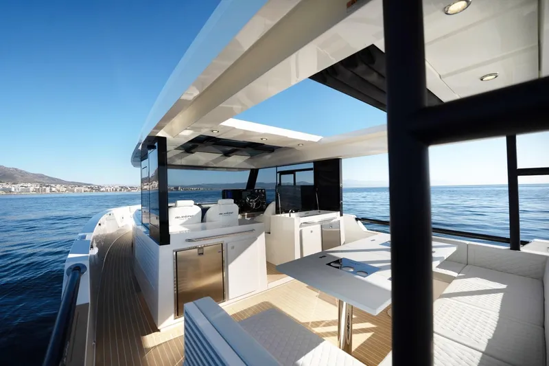 Slide: The Image of 2026 De Antonio Yachts 50 Coupe, luxurious deck view, modern design, open sea backdrop. - 10
