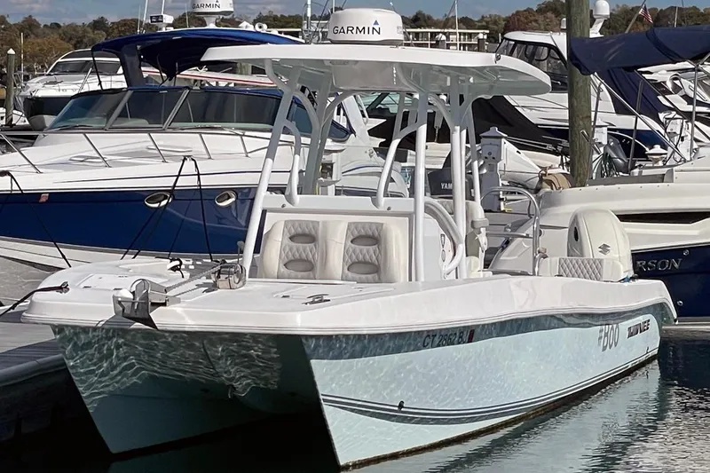 The Image of 2021 Twin Vee 260 VIVA boat docked at marina, featuring Garmin equipment. - 0