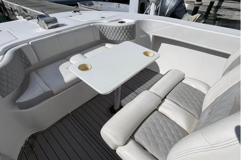 Slide: The Image of 2021 Twin Vee 260 VIVA boat interior with cushioned seating and table. - 4