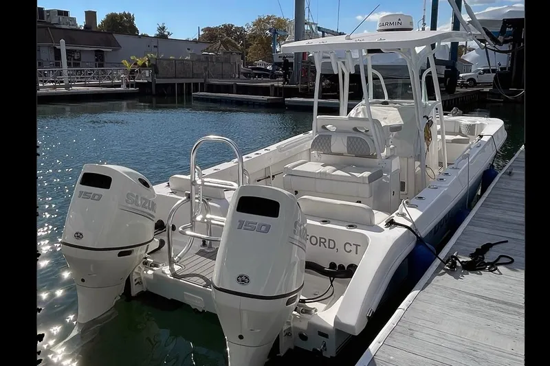 Slide: The Image of 2021 Twin Vee 260 VIVA boat docked, featuring dual Suzuki 150 engines. - 9