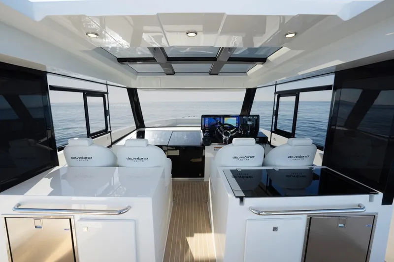 Slide: The Image of Interior of 2026 De Antonio Yachts 50 Coupe, featuring modern helm and luxurious seating. - 14