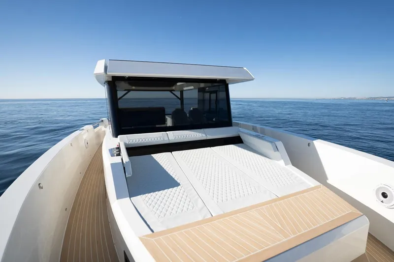 Slide: The Image of 2026 De Antonio Yachts 50 Coupe on calm sea, showcasing sleek design and spacious deck. - 8