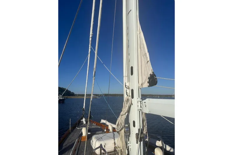 Slide: The Image of 1983 Camper & Nicholsons Cutter Rig sailboat mast and rigging on calm water. - 10