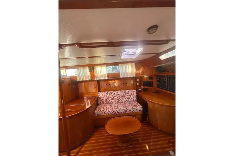 Slide: The Image of Interior of 1983 Camper & Nicholsons Cutter Rig with wooden furnishings and patterned seating. - 16