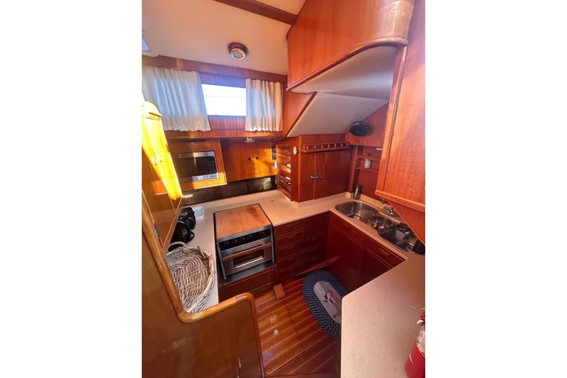 Slide: The Image of 1983 Camper & Nicholsons Cutter Rig yacht kitchen with wood cabinetry and modern appliances. - 17