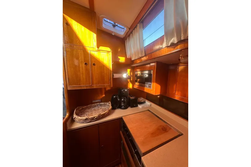 Slide: The Image of 1983 Camper & Nicholsons Cutter Rig kitchen with wooden cabinets and modern appliances. - 18