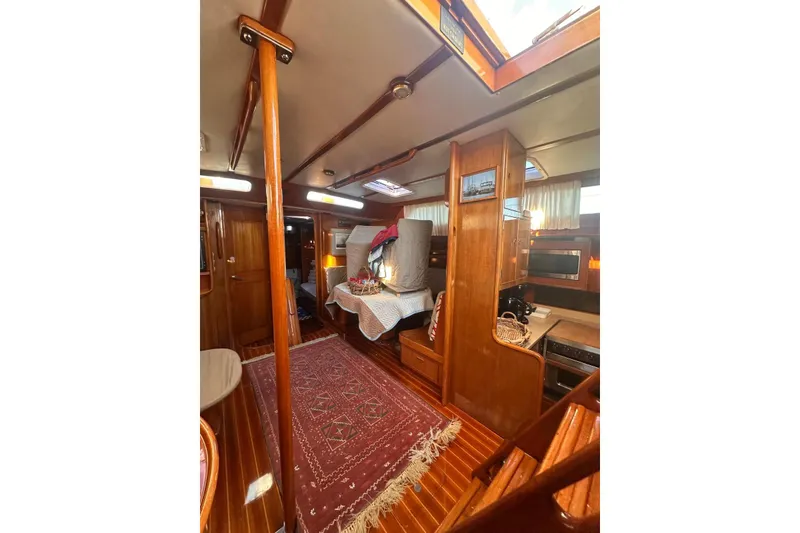 Slide: The Image of Interior of 1983 Camper & Nicholsons Cutter Rig, featuring wood finishes and cozy decor. - 20
