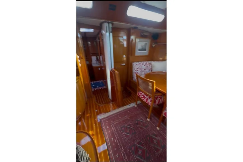 Slide: The Image of Interior of 1983 Camper & Nicholsons Cutter Rig, featuring wood finishes and cozy seating. - 22