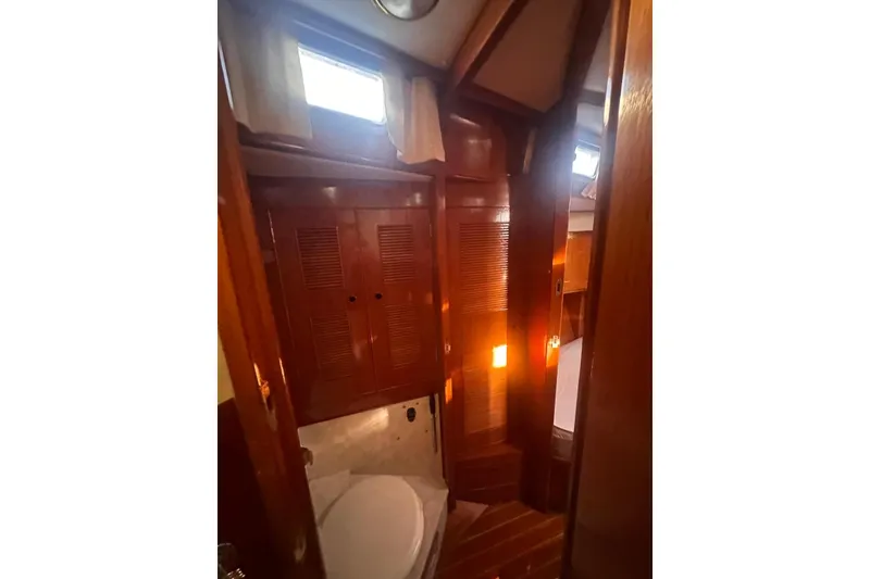 Slide: The Image of Interior of 1983 Camper & Nicholsons Cutter Rig, featuring wooden cabinetry and natural light. - 25