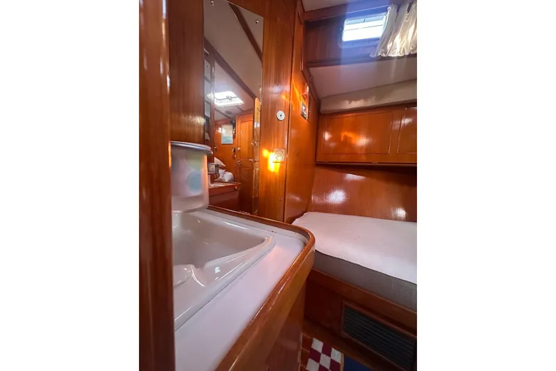 Slide: The Image of 1983 Camper & Nicholsons Cutter Rig interior with wooden finish and cozy cabin space. - 26