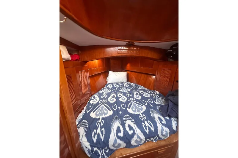 Slide: The Image of Cozy cabin interior of 1983 Camper & Nicholsons Cutter Rig with wooden finish and patterned bedding. - 28
