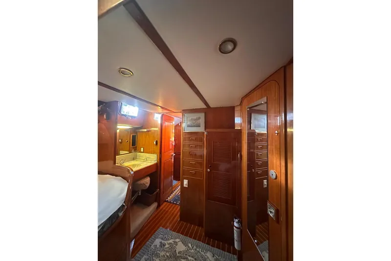 Slide: The Image of Interior of 1983 Camper & Nicholsons Cutter Rig, featuring wood paneling and cozy cabin amenities. - 37