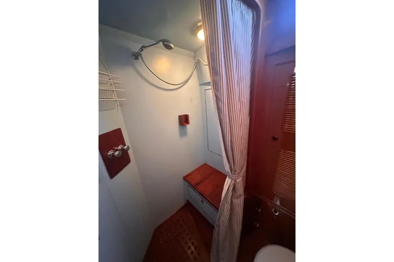 Slide: The Image of 1983 Camper & Nicholsons Cutter Rig bathroom with shower, curtain, and wooden accents. - 39