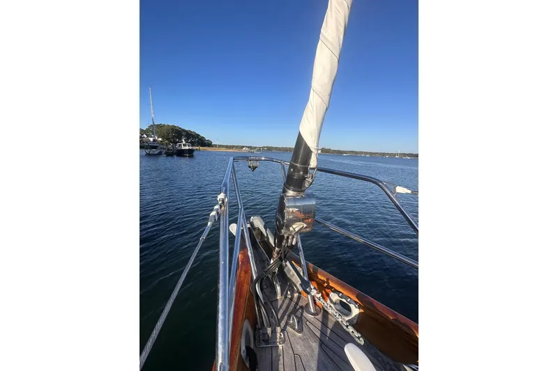 Slide: The Image of 1983 Camper & Nicholsons Cutter Rig sailboat on calm water, clear blue sky. - 4