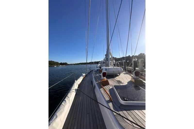 Slide: The Image of 1983 Camper & Nicholsons Cutter Rig sailboat deck with clear blue sky and calm waters. - 5