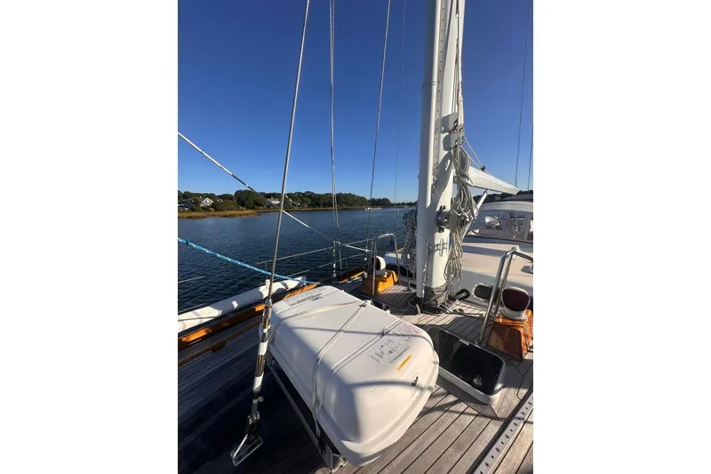 Slide: The Image of 1983 Camper & Nicholsons Cutter Rig sailboat deck with clear blue sky and calm waters. - 6