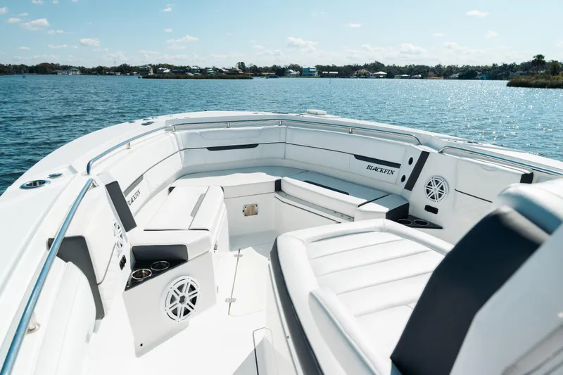 Slide: The Image of 2021 Blackfin 332 CC boat interior with white seating on a sunny day. - 1