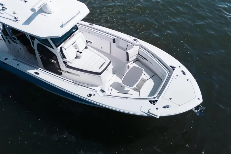 Slide: The Image of 2021 Blackfin 332 CC boat on water, showcasing sleek design and spacious deck. - 104
