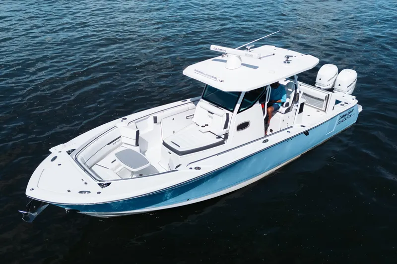 Slide: The Image of 2021 Blackfin 332 CC boat on water, featuring sleek design and dual engines. - 105