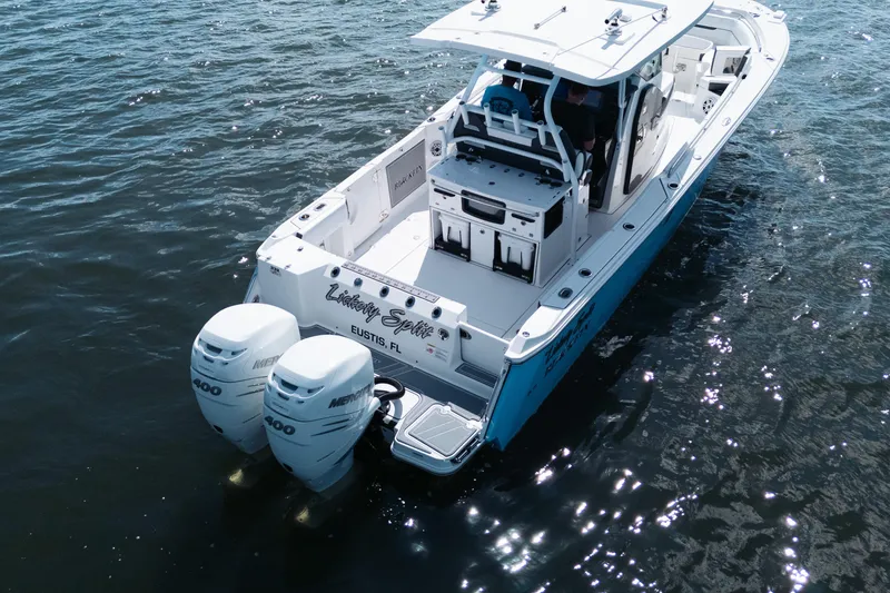 Slide: The Image of 2021 Blackfin 332 CC boat with twin Mercury 400 engines on water. - 106