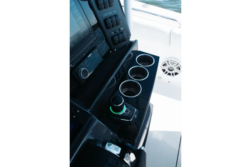 Slide: The Image of 2021 Blackfin 332 CC boat console with cup holders and control panel. - 12