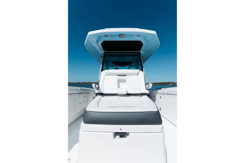 Slide: The Image of 2021 Blackfin 332 CC boat with sleek seating and canopy on open water. - 2