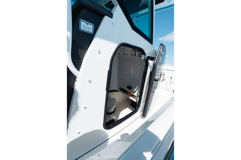 Slide: The Image of 2021 Blackfin 332 CC boat cabin interior with open door, showcasing modern design. - 20