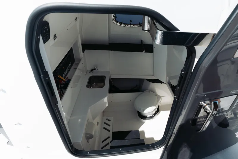 Slide: The Image of Interior view of 2021 Blackfin 332 CC boat cabin with sink and toilet. - 22