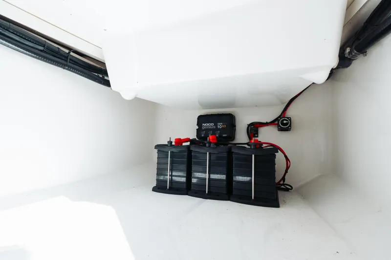 Slide: The Image of 2021 Blackfin 332 CC boat battery compartment with NOCO Genius charger. - 23